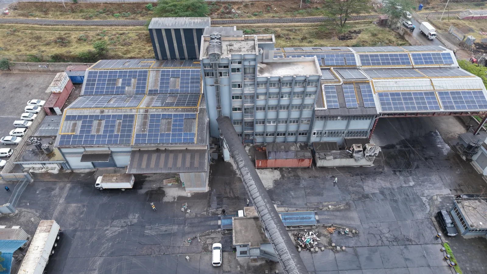 Rooftop solar panels on the production buildings beside the Kabansora Millers mill tower