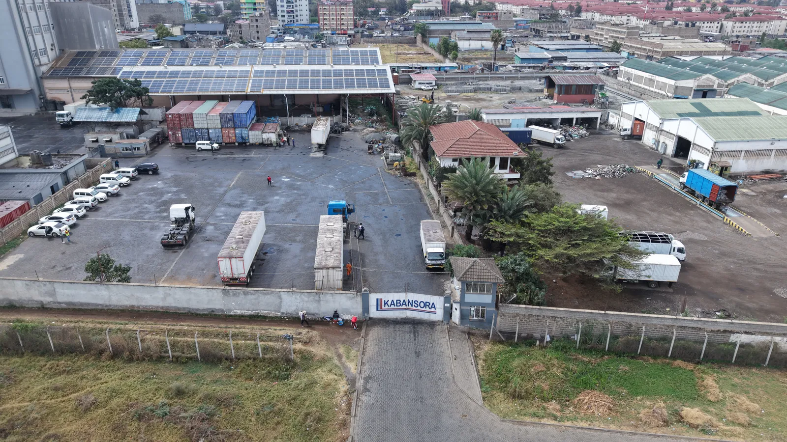 Kabansora Millers site entrance and yard, with solar panels visible on the warehouse roof