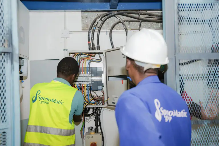 Spenomatic engineers working on an electrical control panel